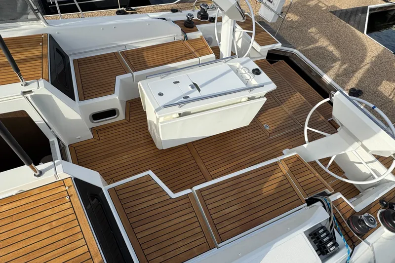 Yacht Photos Pics 2023 Beneteau Oceanis 46.1 yacht deck with elegant wood finish and modern steering.