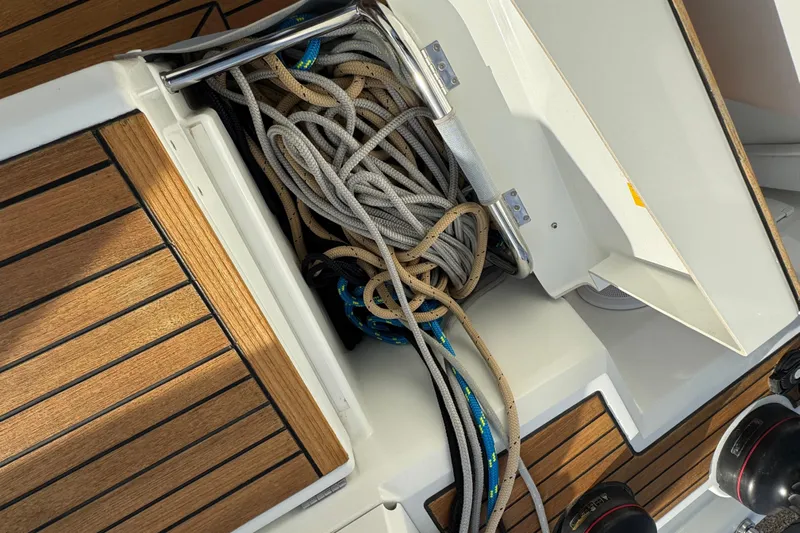  Yacht Photos Pics Beneteau Oceanis 46.1 (2023) sailboat deck with ropes and wooden flooring.