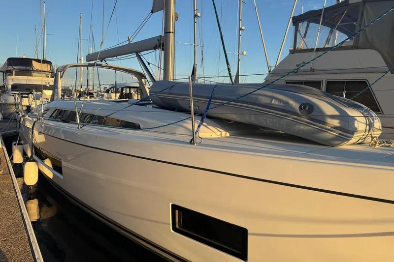  Yacht Photos Pics 2023 Beneteau Oceanis 46.1 yacht docked with inflatable boat on deck.