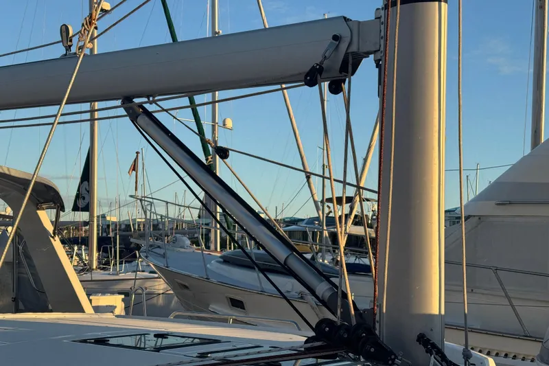  Yacht Photos Pics 2023 Beneteau Oceanis 46.1 sailboat mast and rigging in marina at sunset.