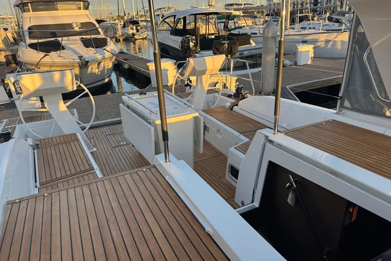  Yacht Photos Pics 2023 Beneteau Oceanis 46.1 yacht docked, showcasing elegant teak deck and modern design.