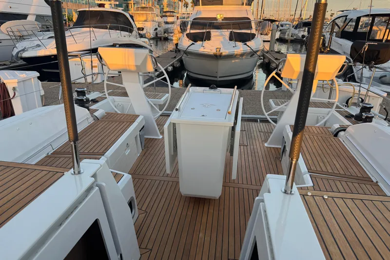  Yacht Photos Pics Beneteau Oceanis 46.1 yacht deck, 2023 model, featuring dual steering wheels and teak flooring.