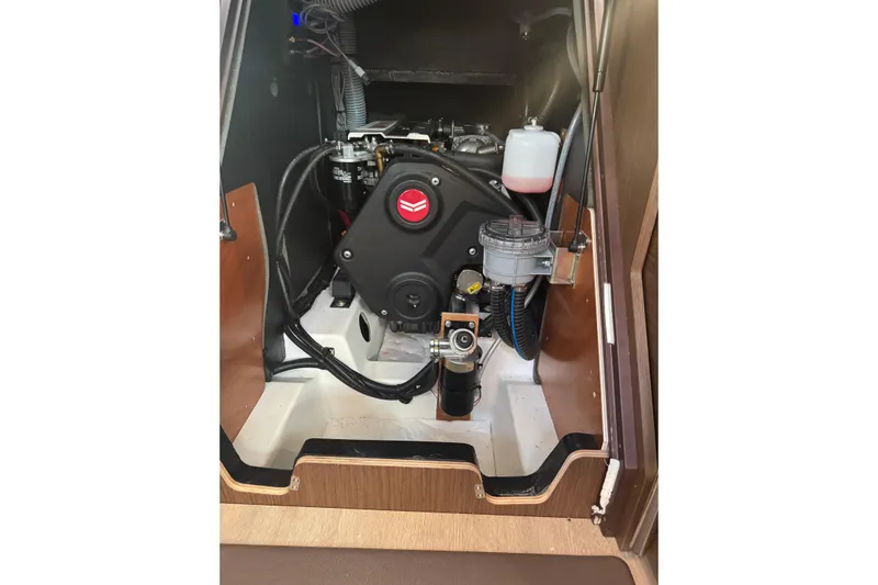  Yacht Photos Pics Engine compartment of 2023 Beneteau Oceanis 46.1 sailboat, showcasing mechanical components.