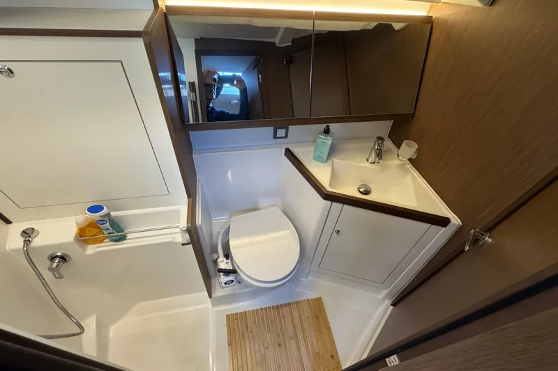  Yacht Photos Pics 2023 Beneteau Oceanis 46.1 yacht bathroom with modern fixtures and wooden accents.