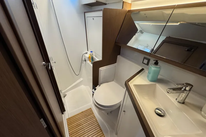  Yacht Photos Pics Modern bathroom in 2023 Beneteau Oceanis 46.1 yacht with shower, sink, and toilet.