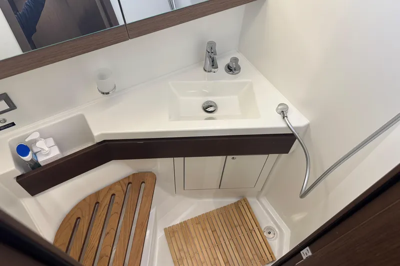  Yacht Photos Pics Modern bathroom in 2023 Beneteau Oceanis 46.1 yacht with sink and shower.