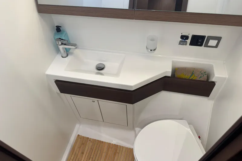  Yacht Photos Pics Modern bathroom in 2023 Beneteau Oceanis 46.1 yacht with sleek sink and fixtures.