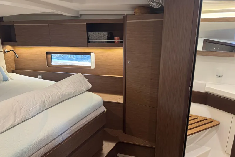  Yacht Photos Pics Luxurious interior cabin of 2023 Beneteau Oceanis 46.1 yacht with modern wood finish.