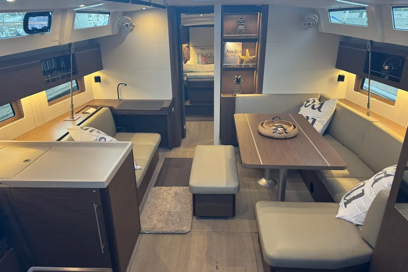  Yacht Photos Pics Interior of 2023 Beneteau Oceanis 46.1 yacht, featuring modern seating and dining area.