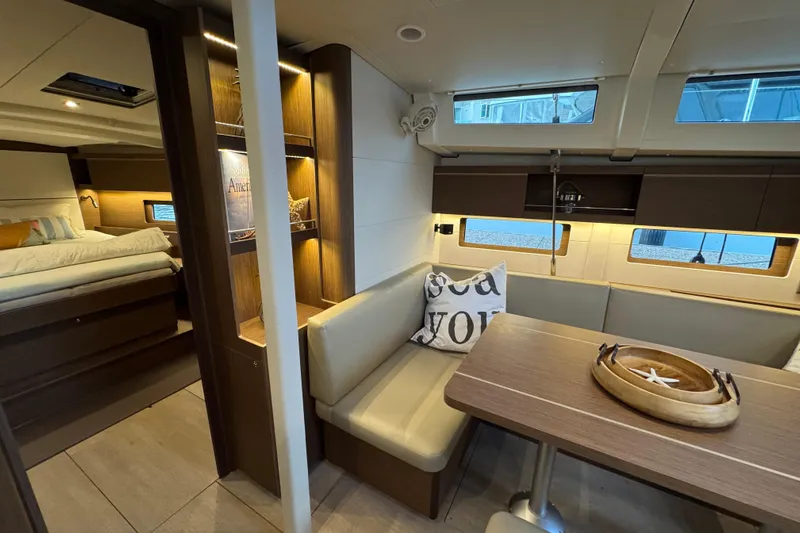  Yacht Photos Pics Luxurious interior of 2023 Beneteau Oceanis 46.1 yacht with cozy seating and elegant decor.