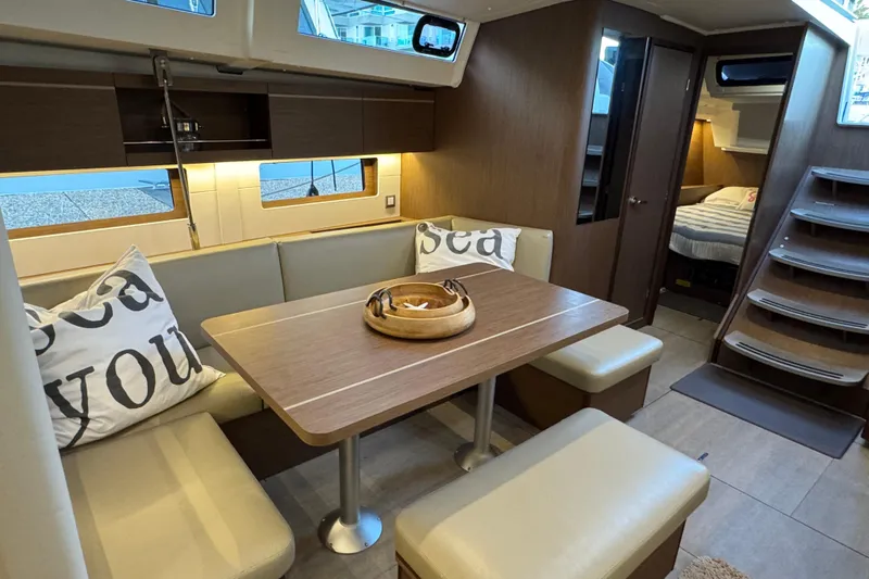  Yacht Photos Pics Luxurious interior of 2023 Beneteau Oceanis 46.1 yacht with cozy dining area.