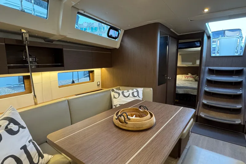  Yacht Photos Pics Luxurious interior of 2023 Beneteau Oceanis 46.1 yacht with modern dining area.