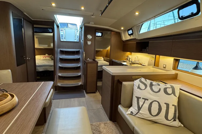  Yacht Photos Pics Luxurious interior of 2023 Beneteau Oceanis 46.1 yacht with modern amenities and cozy seating.