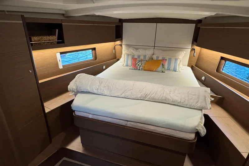  Yacht Photos Pics Luxurious cabin interior of 2023 Beneteau Oceanis 46.1 yacht with cozy bedding.