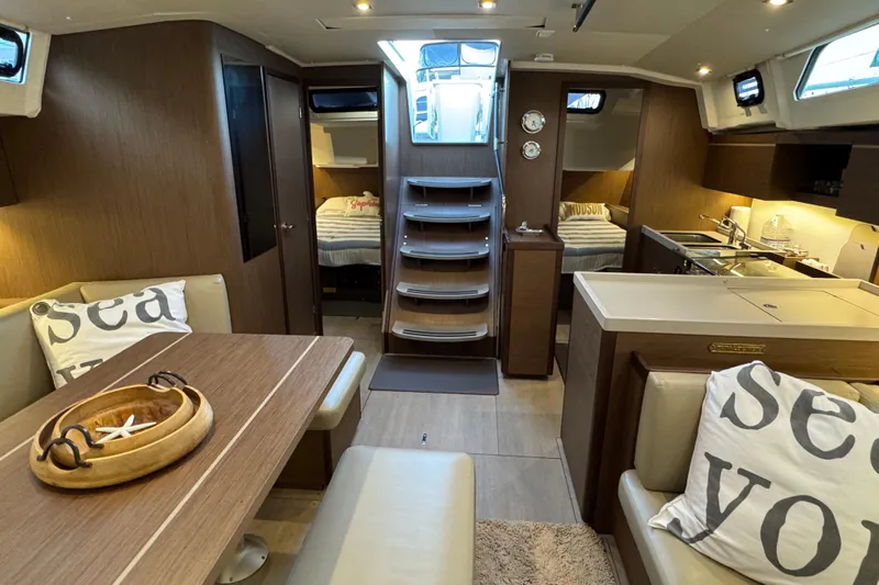  Yacht Photos Pics Interior of 2023 Beneteau Oceanis 46.1 yacht, featuring modern dining and kitchen area.
