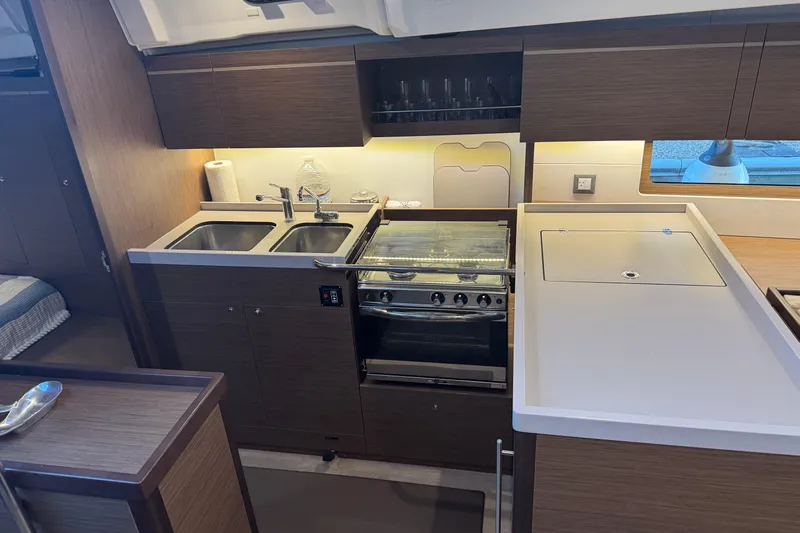  Yacht Photos Pics Modern kitchen in 2023 Beneteau Oceanis 46.1 yacht with dual sinks and stove.