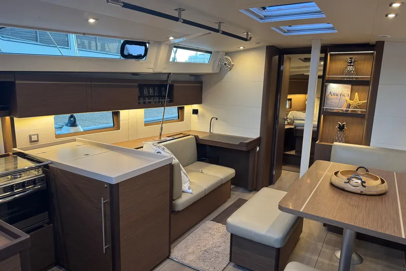  Yacht Photos Pics Luxurious interior of 2023 Beneteau Oceanis 46.1 yacht with modern kitchen and dining area.