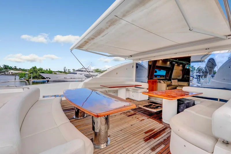  Yacht Photos Pics Luxurious 2007 Sunseeker Predator 108 yacht with spacious outdoor seating and polished wooden tables.