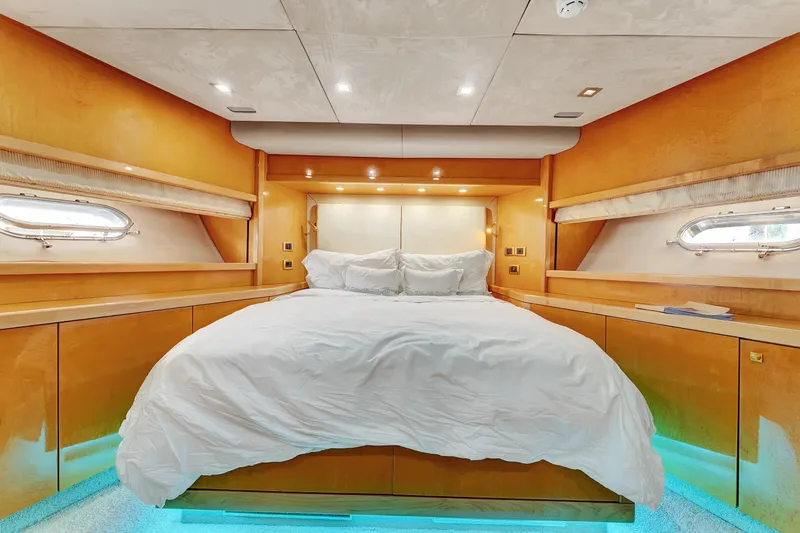  Yacht Photos Pics Luxurious bedroom interior of 2007 Sunseeker Predator 108 yacht with elegant wood finish.