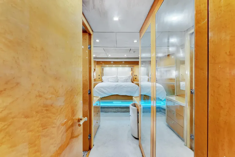  Yacht Photos Pics Luxurious bedroom interior of 2007 Sunseeker Predator 108 yacht with elegant wood finishes.