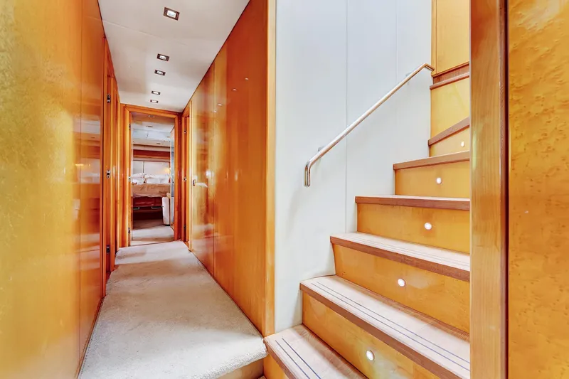  Yacht Photos Pics Luxurious interior of 2007 Sunseeker Predator 108 yacht with wooden stairs and hallway.