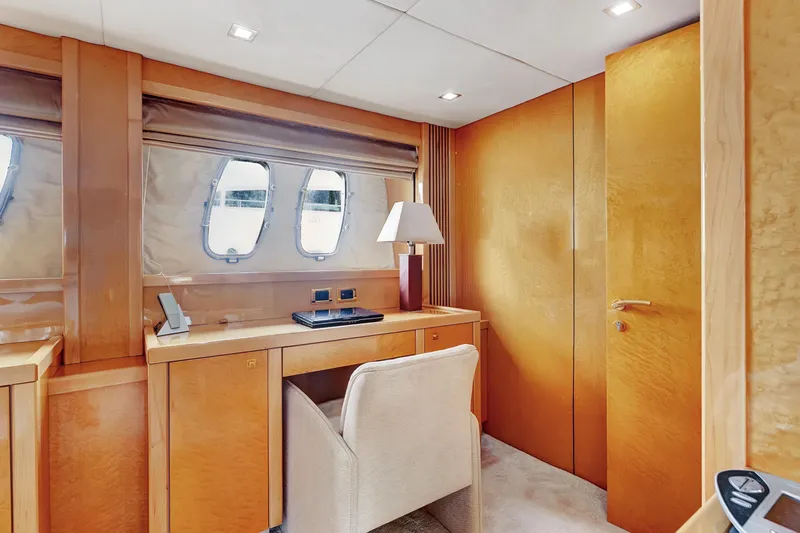  Yacht Photos Pics Luxurious interior of 2007 Sunseeker Predator 108 yacht with elegant wood finish and desk area.