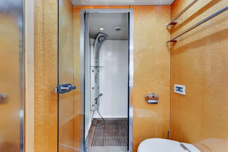 Yacht Photos Pics Luxurious bathroom on 2007 Sunseeker Predator 108 yacht with modern shower and wooden accents.