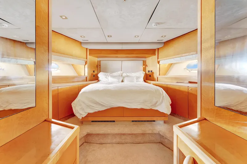  Yacht Photos Pics Luxurious bedroom interior on 2007 Sunseeker Predator 108 yacht, featuring elegant wood finishes.