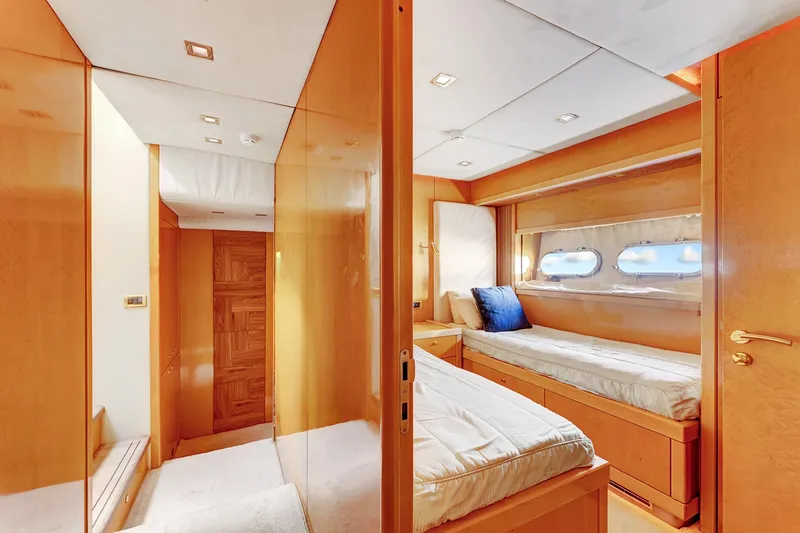  Yacht Photos Pics Luxurious cabin interior of 2007 Sunseeker Predator 108 yacht with twin beds and porthole windows.