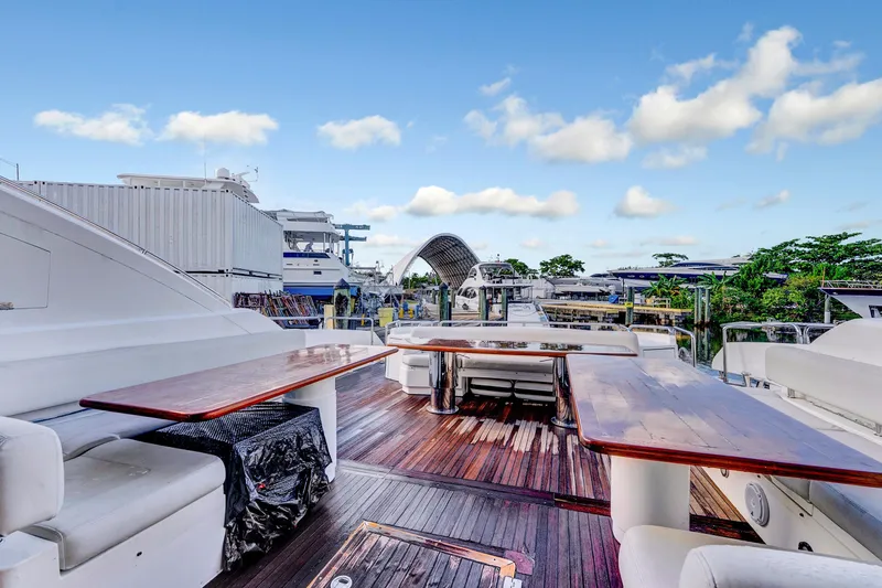  Yacht Photos Pics Luxurious 2007 Sunseeker Predator 108 yacht deck with seating and tables, docked at marina.