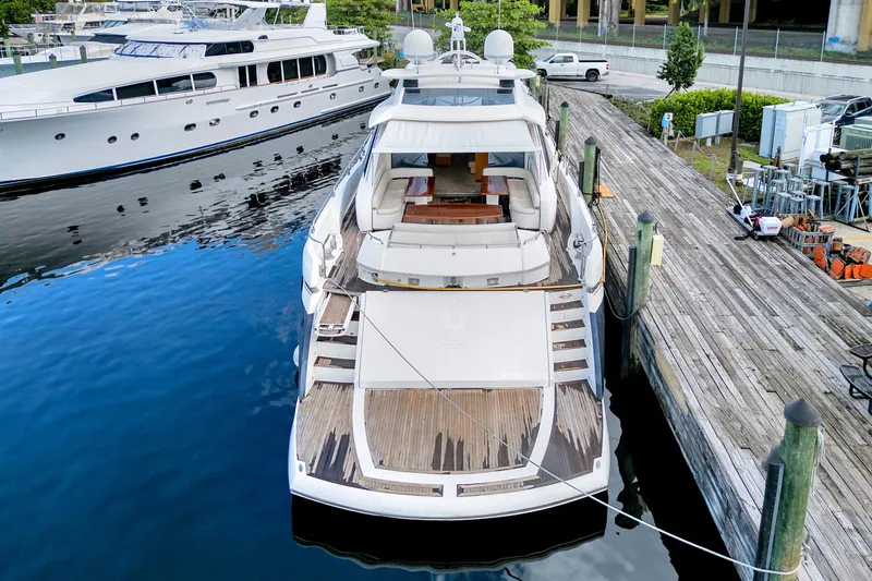  Yacht Photos Pics Sunseeker Predator 108 yacht, 2007 model, docked at marina with wooden deck.