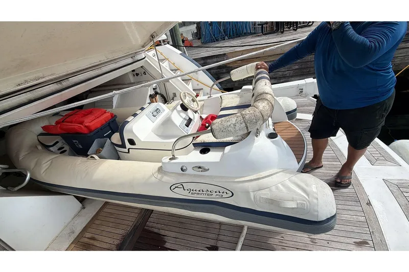  Yacht Photos Pics Inflatable boat on Sunseeker Predator 108 yacht, 2007 model, docked with a person nearby.