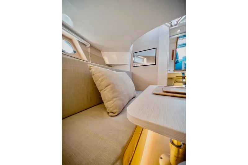 Oasis Yacht Photos Pics 2022 Tesoro T40 Inboard interior with beige seating and modern design.
