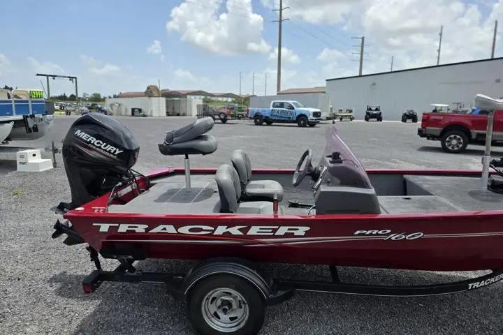 2020 Tracker Pro 160 boat with Mercury engine in a parking lot.