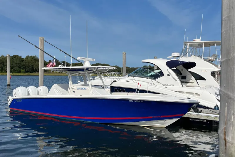  Yacht Photos Pics 2020 Jupiter 34 Center Console boat docked, blue hull, white interior, sunny day.