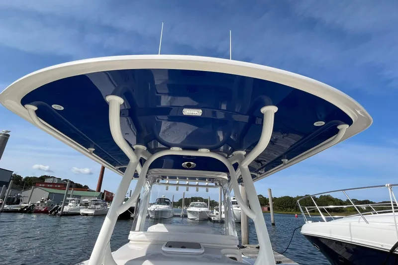  Yacht Photos Pics 2020 Jupiter 34 Center Console boat docked, showcasing sleek design and blue canopy.