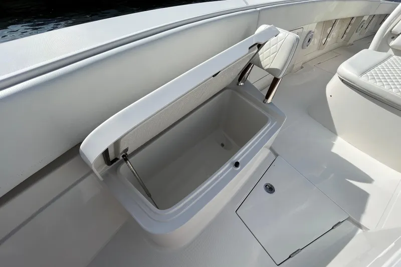  Yacht Photos Pics Open storage compartment on 2020 Jupiter 34 Center Console boat, featuring sleek white interior design.