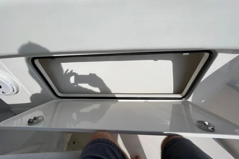  Yacht Photos Pics 2020 Jupiter 34 Center Console storage compartment with open hatch and shadow reflection.