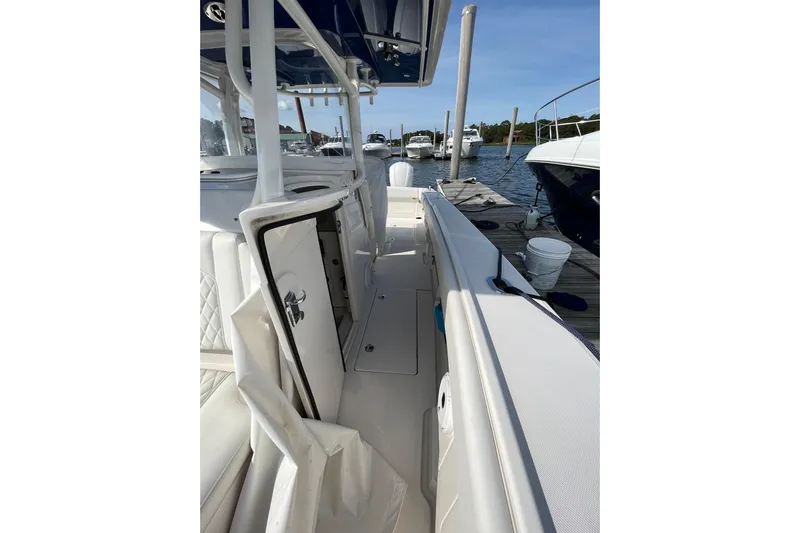  Yacht Photos Pics 2020 Jupiter 34 Center Console boat docked, showcasing sleek interior and storage compartments.