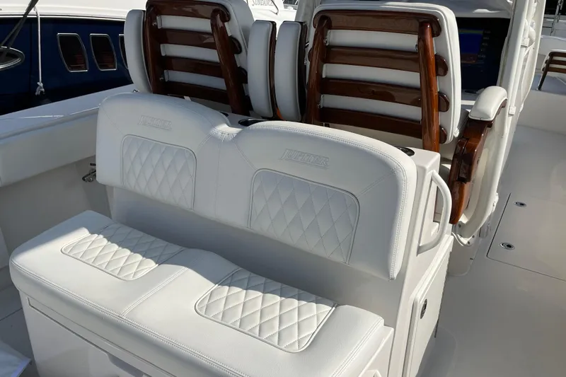  Yacht Photos Pics 2020 Jupiter 34 Center Console boat with white cushioned seating and wooden accents.
