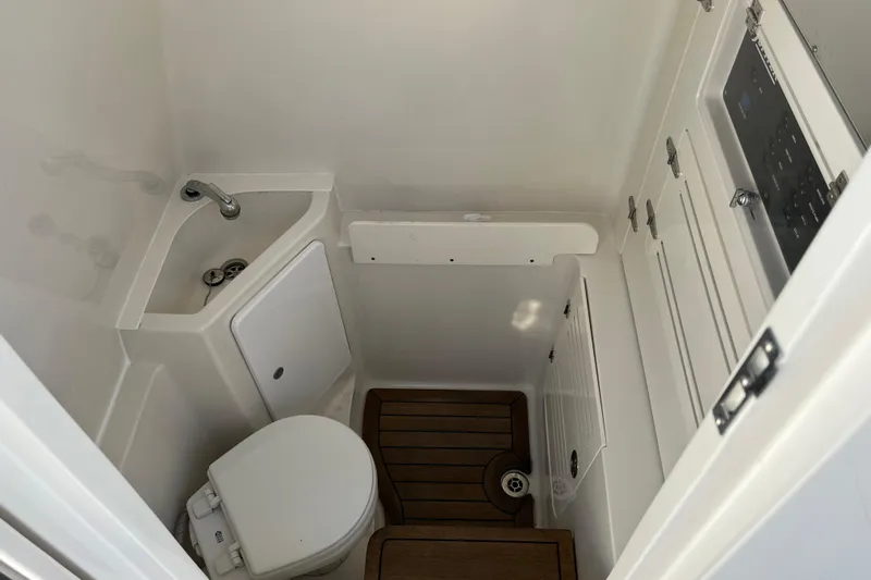  Yacht Photos Pics 2020 Jupiter 34 Center Console boat bathroom with compact sink and toilet.