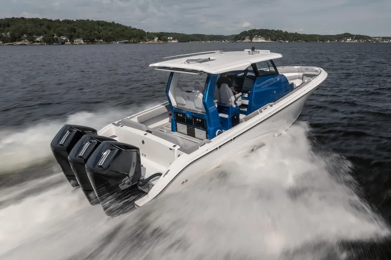  Yacht Photos Pics 2026 Fountain 43 SCX boat speeding on water with triple outboard engines.