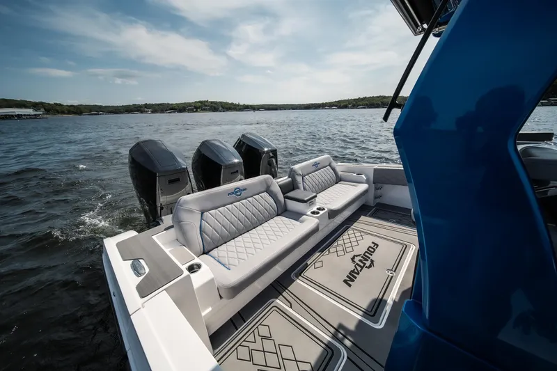  Yacht Photos Pics 2026 Fountain 43 SCX boat with luxurious seating and powerful engines on a serene lake.