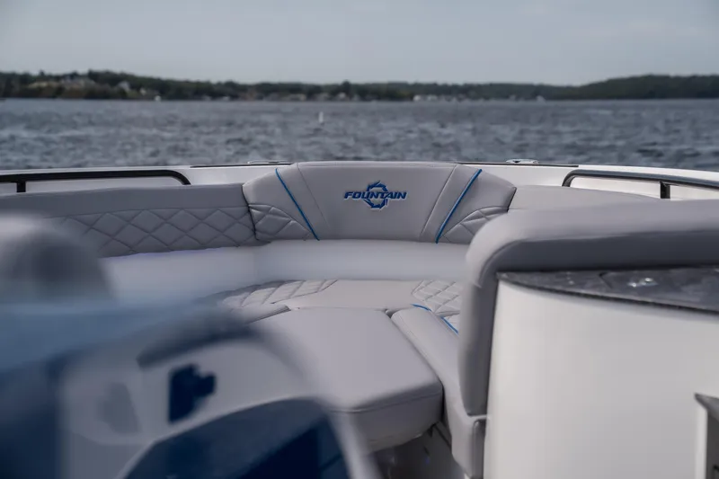  Yacht Photos Pics 2026 Fountain 43 SCX boat interior with luxurious seating on a serene lake.