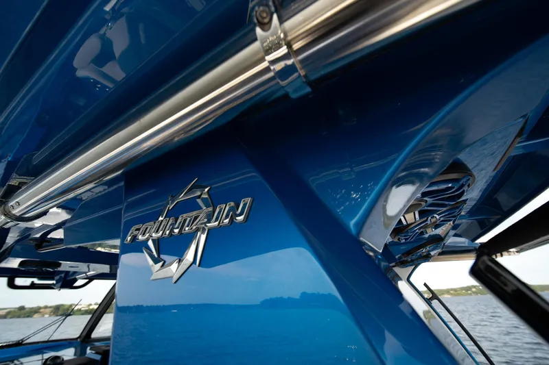  Yacht Photos Pics 2026 Fountain 43 SCX boat, close-up of sleek blue exterior and logo.