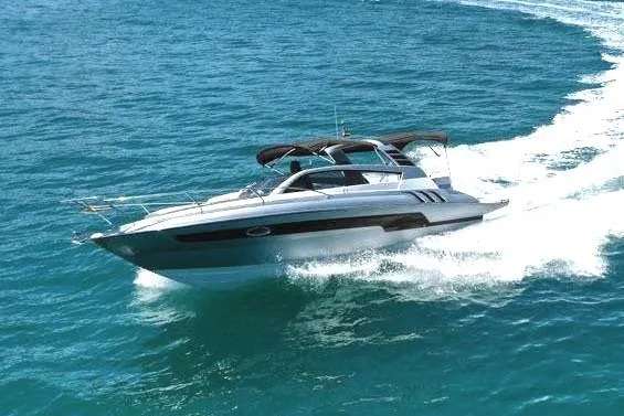 Custom Order Your 305 Today! Yacht Photos Pics 2025 Hanover 305 Inboard cruising on open sea with scenic mountain backdrop.
