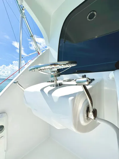 Red Queen Yacht Photos Pics 2008 Hatteras Enclosed Bridge yacht detail with stainless steel fittings and ocean backdrop.