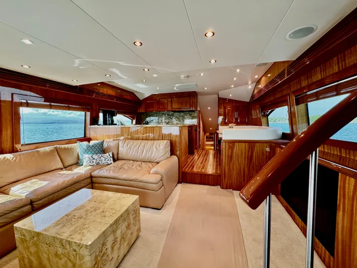 Red Queen Yacht Photos Pics Luxurious interior of 2008 Hatteras Enclosed Bridge yacht with plush seating and elegant wood finishes.