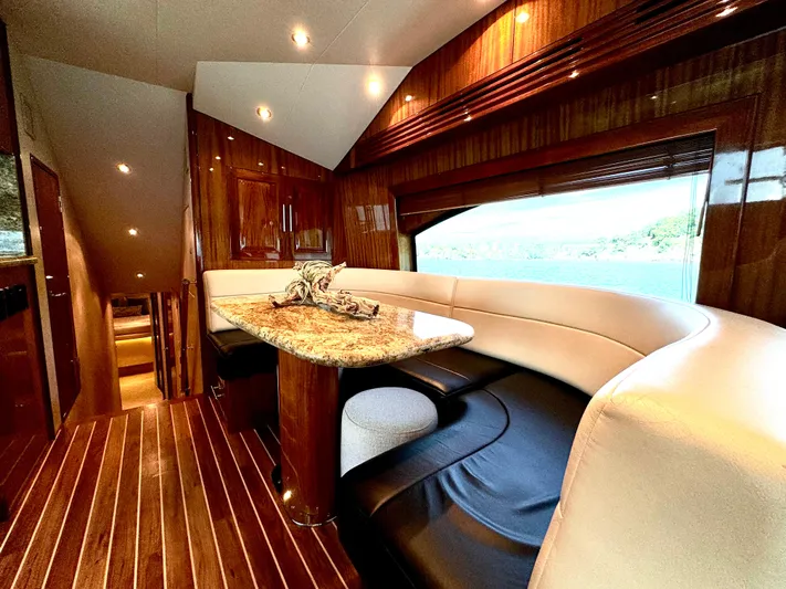 Red Queen Yacht Photos Pics Luxurious 2008 Hatteras Enclosed Bridge yacht interior with elegant wood and leather seating.