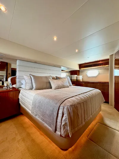 Red Queen Yacht Photos Pics Luxurious bedroom interior of 2008 Hatteras Enclosed Bridge yacht with elegant bedding and wood accents.